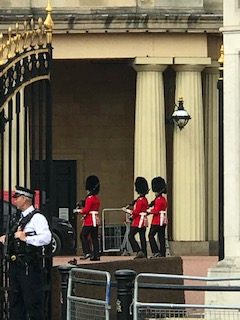 Changing of the Guards Ceremony in London with Guards dressed in red, white, and black uniforms