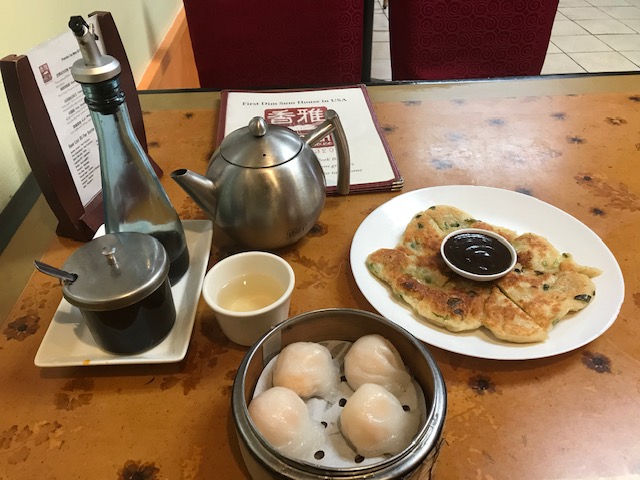 alt = "Shrimp dumplings, scallion pancakes, and green tea at Hang Ah Tea Room".