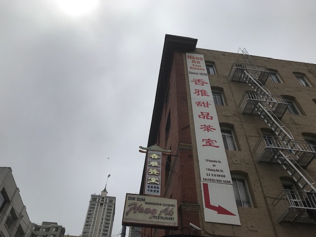 alt = "Hang Ah Tea Room Sign with arrow pointing downward".