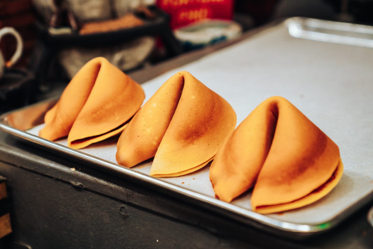 alt = "Fortune Cookies on a baking sheet".