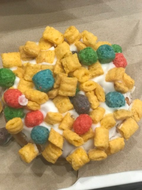 alt = "Oh Captain, My Captain donut with Cap'N crunch cereal pieces and vanilla frosting".