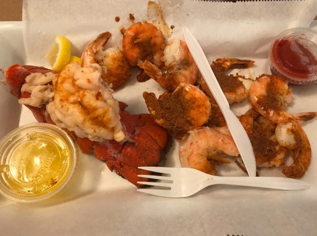 alt txt = "Close-up of shrimp and lobster dinner at Locust Point Steamers restaurant in Baltimore’s Inner Harbor."