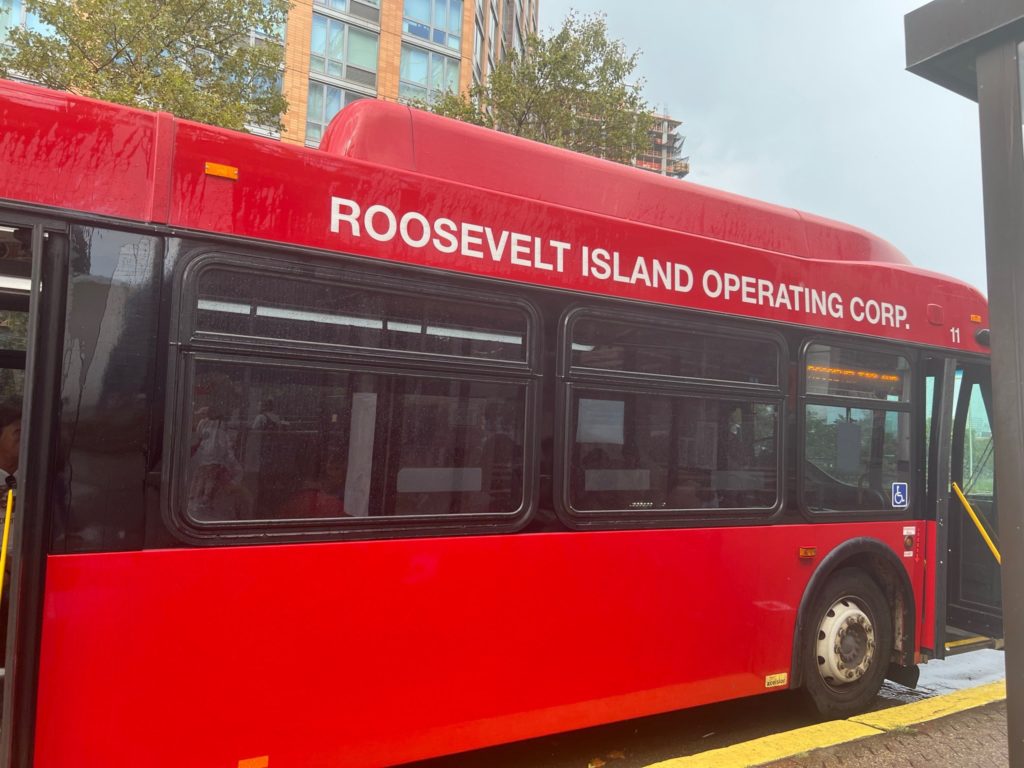 alt txt = "Parked red shuttle bus."