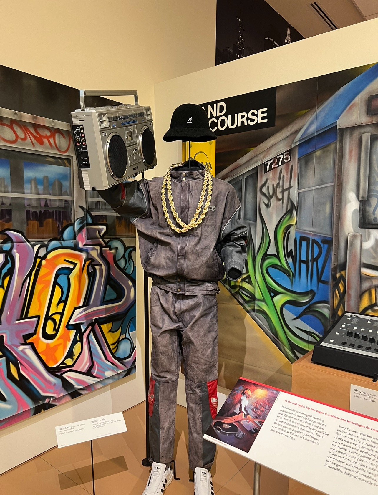 alt txt = "Grey hip hop outfit and NY style graffiti at the Musical Instrument Museum in Phoenix."