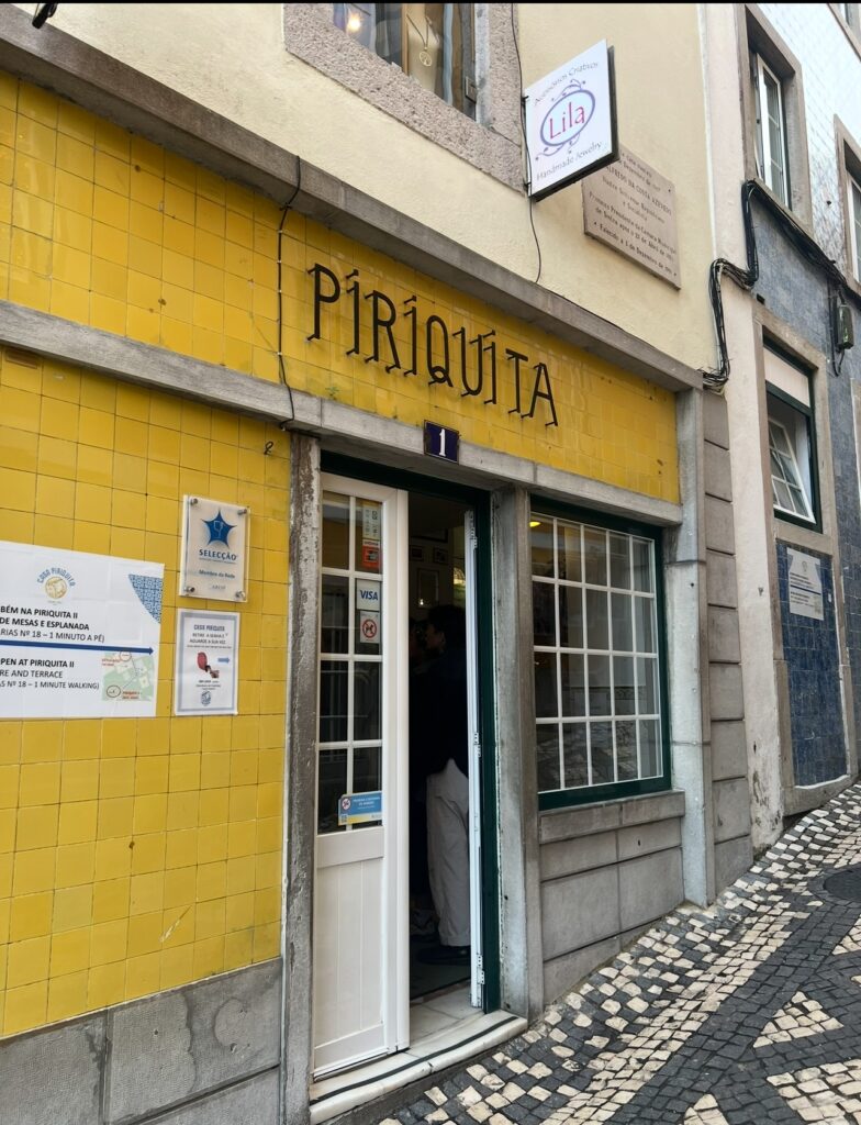 alt txt = "Yellow brick front building with black lettering".