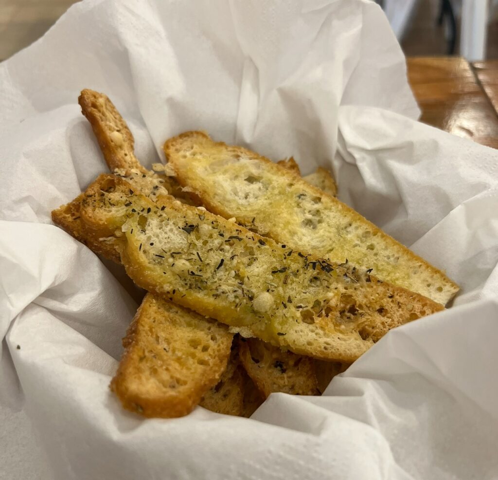 alt txt = "Fresh bread with herbs and garlic".