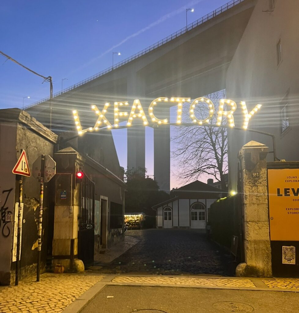 alt txt = "Large sign for street with different restaurants".