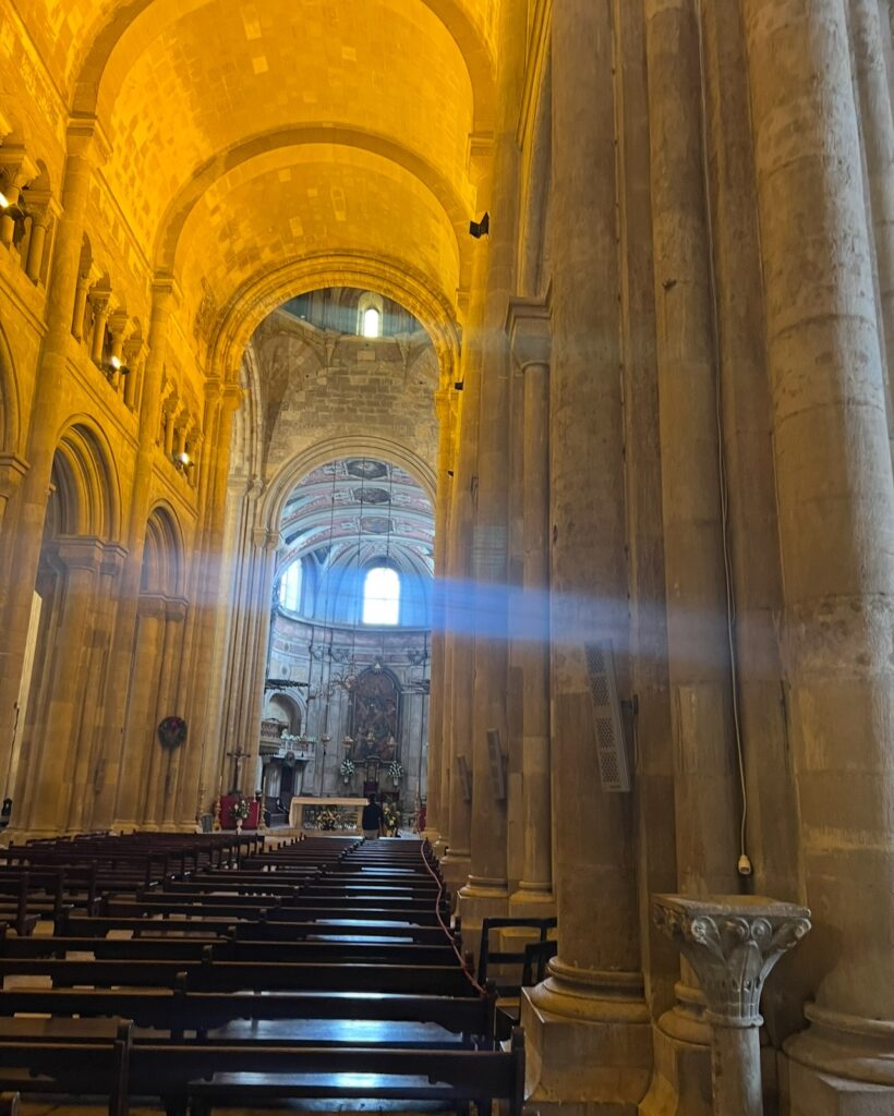 alt txt = "Inside brown concrete building with illuminating light".