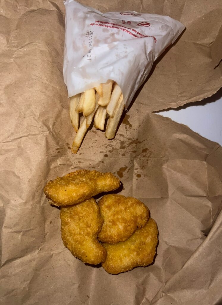 alt txt = "Chicken nuggets and potato French fries".