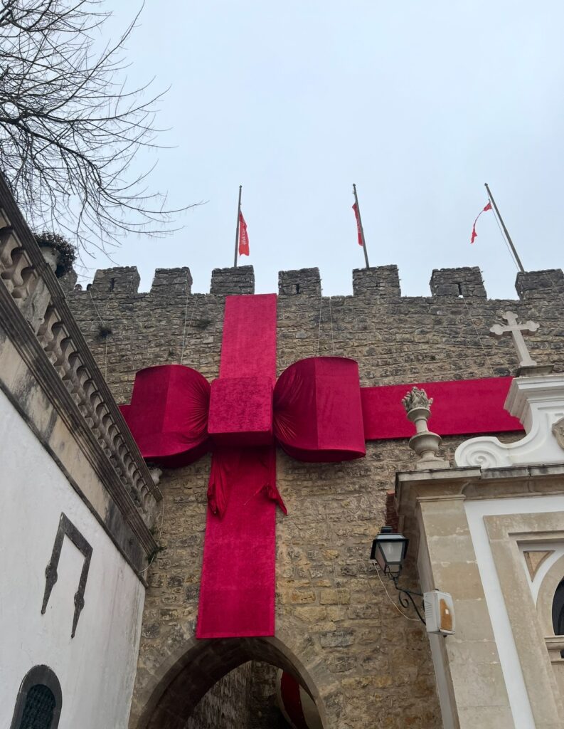 alt txt = "Castle structure with red ribbon".
