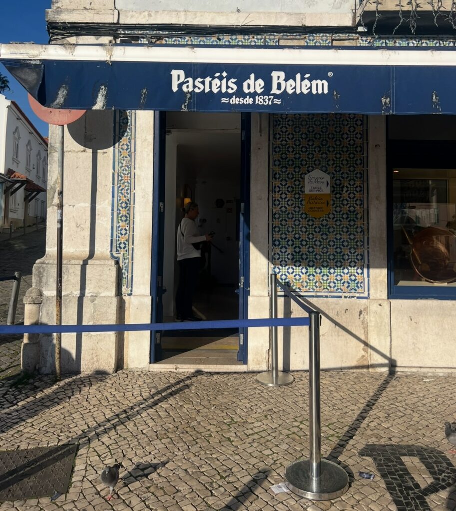 alt txt = "Blue and white sign with blue marble".