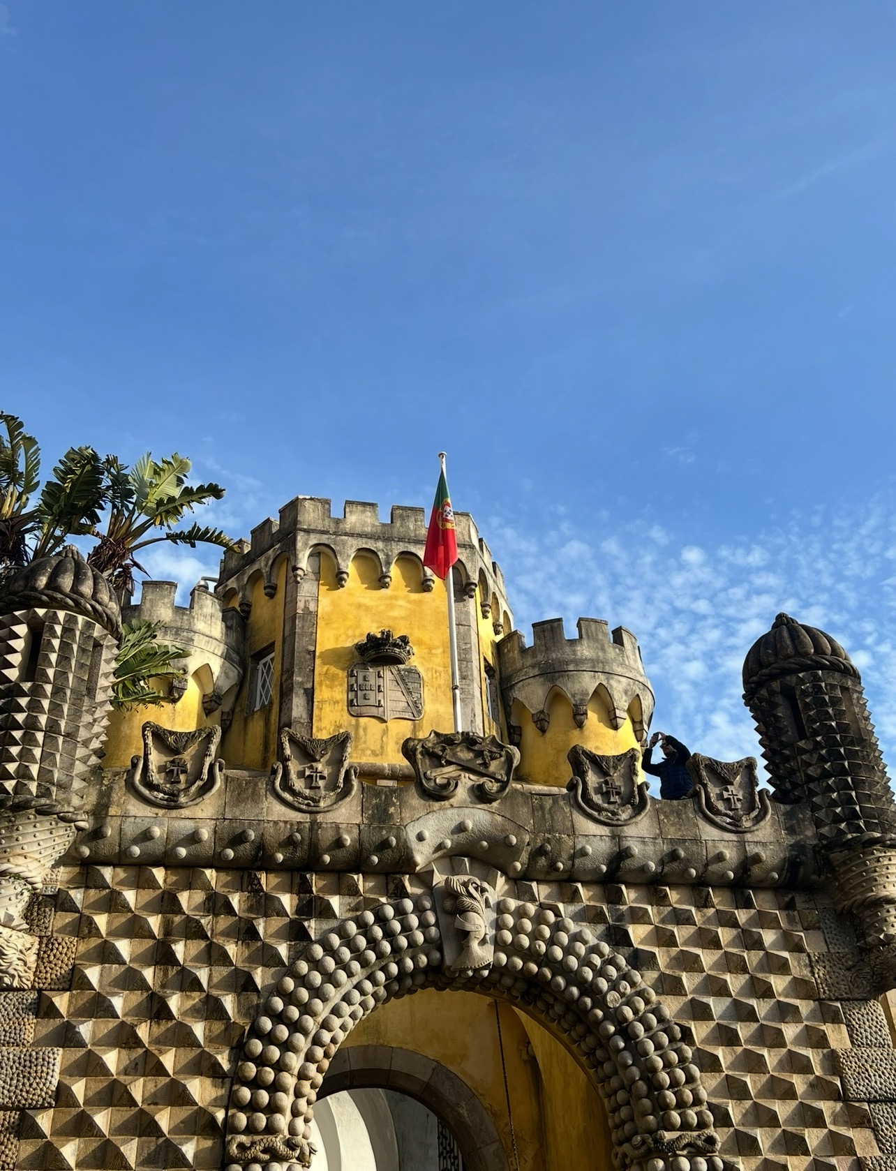 alt txt = "Yellow castle atop large structure".