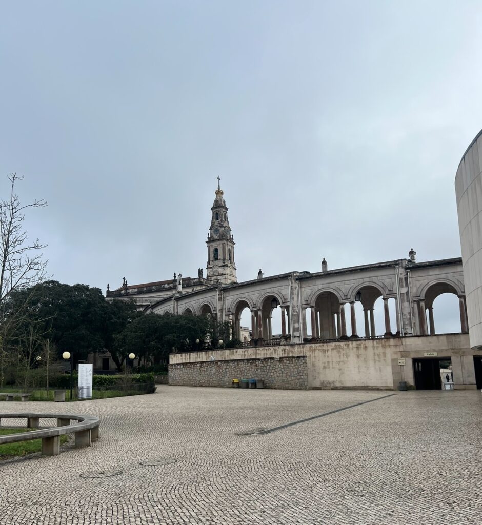 alt txt = "Concrete building under grey skies".